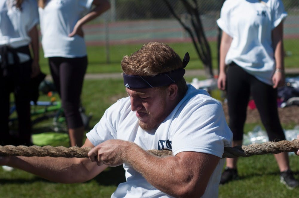 <p>Biochemistry sophomore Marcus Middlebrook plays tug-o-war during the annual Sigma Olympics, hosted by Sigma Kappa, on Sept. 27, 2015, at Patriarche Park in East Lansing.</p>