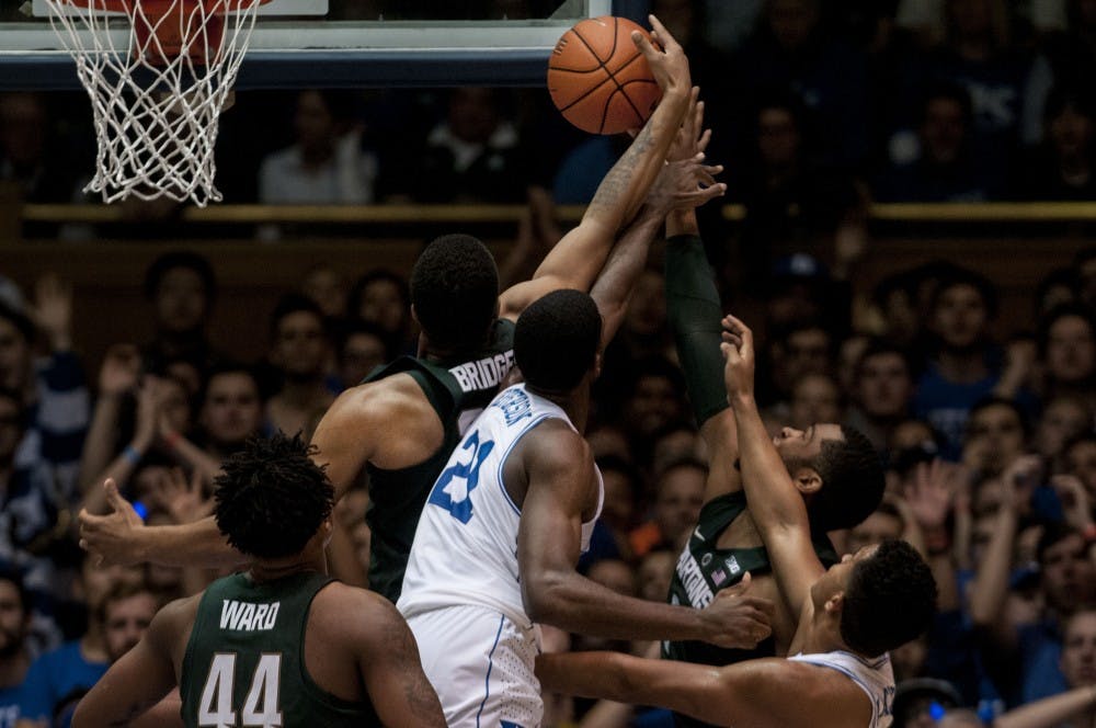Freshman forward Miles Bridges (22) attempts to block a basket from Duke forward Amile Jefferson (21) during the first half of the game against Duke on Nov. 29, 2016 at Cameron Indoor Stadium in Durham, N.C. The Spartans were defeated by the Blue Devils, 69-78. 