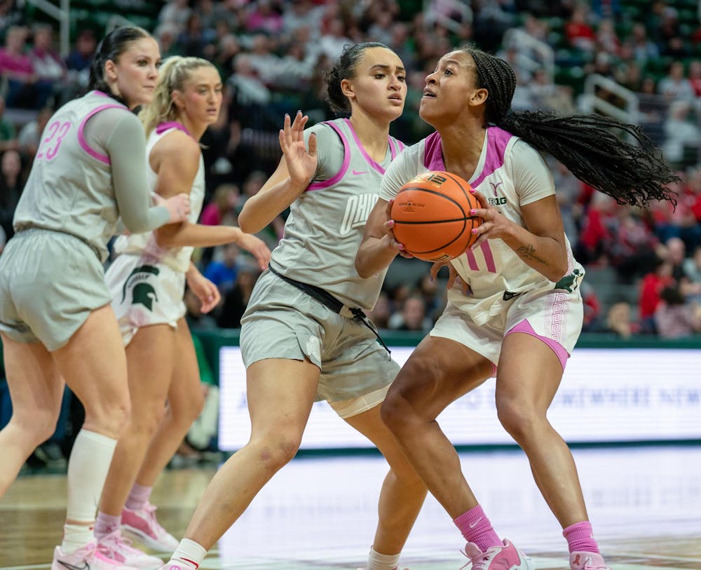 <p>Junior guard/forward Jocelyn Tate (11) gazes towards the basket as opponent graduate guard Celeste Taylor (12) attempts to block her at the Breslin Center on Feb. 11, 2024. The Spartans lost to the Buckeyes 71-86.</p>