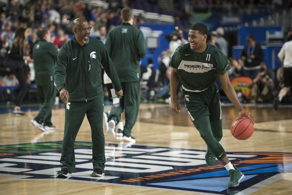 <p>Michigan State assistant coach Mike Garland, left, jokes with freshman forward Aaron Henry (11) during Michigan State&#x27;s NCAA Men&#x27;s Basketball Final Four open practice at U.S. Bank Stadium in Minneapolis on April 5, 2019. </p>