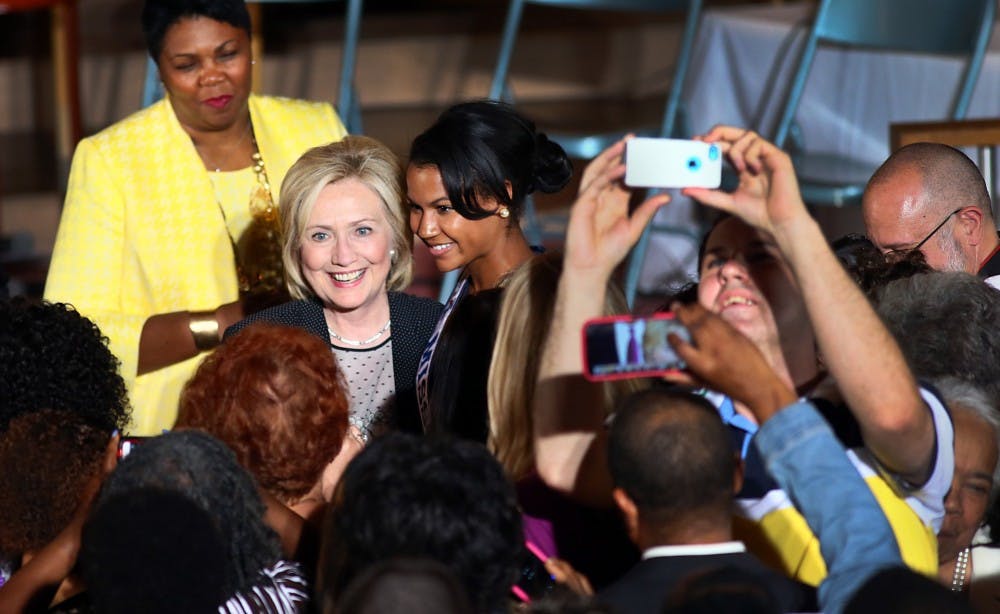 <p>Former U.S. Senator, Secretary of State and presidential candidate Hillary Clinton is greeted by guests at Christ the King United Church of Christ following a community forum in St. Louis on June 23, 2015. </p>