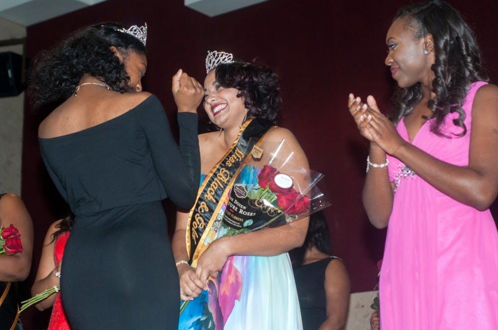 <p>Communications junior Makaila Marshall is crowned Miss Black and Gold by last year's winner, food industry management sophomore DaChana Blaydes, during the Miss Black and Gold beauty pageant put on by the Zelta Delta chapter of the Alpha Phi Alpha fraternity on Nov. 13, 2015 at the Union. Six contestants competed for the title of Miss Black and Gold and the accompanying scholarship. </p>