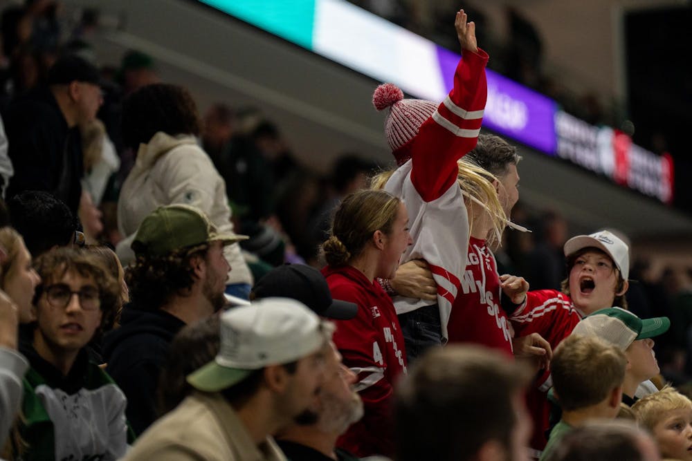 <p>Wisconsin fans celebrate after a win against Michigan State during a hockey game at Munn Ice Arena in East Lansing, Mich., on Saturday, Nov. 22, 2025.</p>