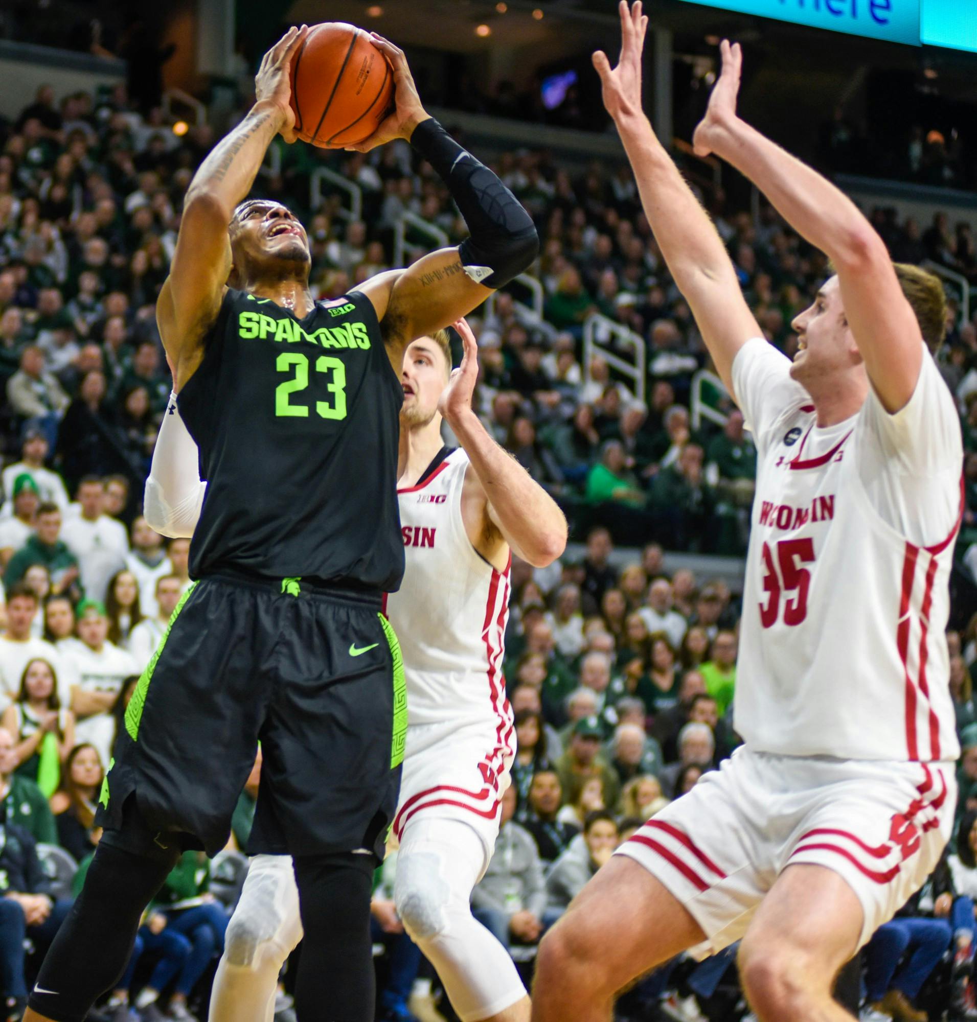 <p>Junior forward Xavier Tillman (23) shoots the ball during the game against Wisconsin on Jan. 17, 2020 at Breslin Center. The Spartans lead the Badgers at the half, 35-20.</p>