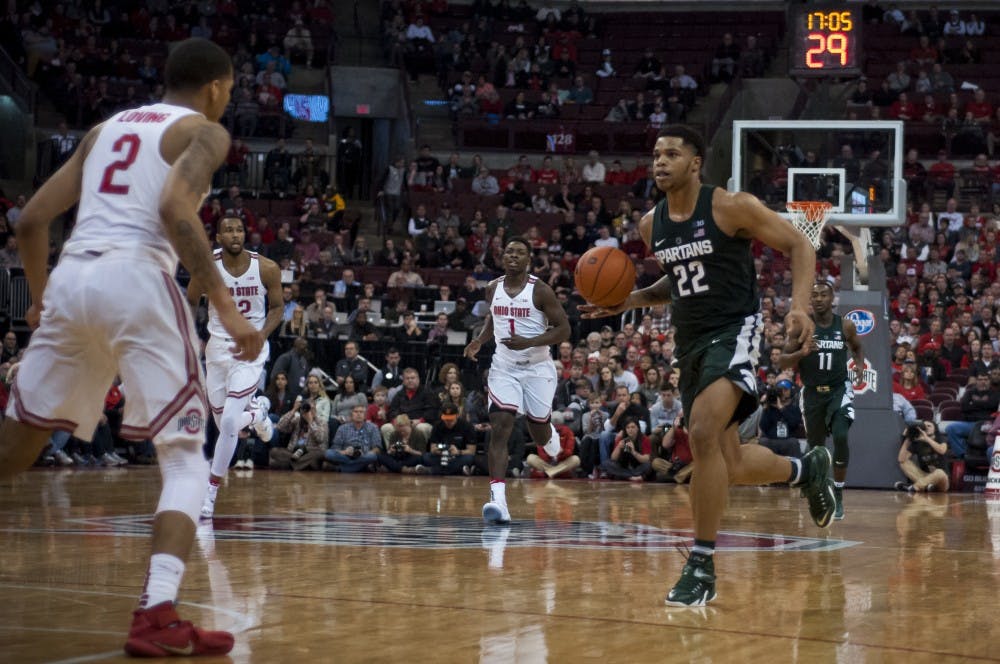 Freshman forward and guard Miles Bridges (22) pushes the ball up the court as Ohio State forward Marc Loving (2) prepares to stop him  during the game against Ohio State on Jan. 15, 2017 at the Jerome Schottenstein Center.The Spartans were defeated by the Buckeyes, 67-72.