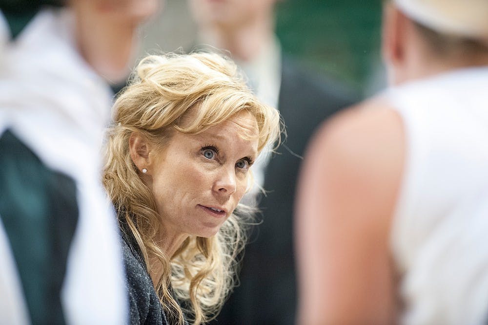 	<p>Head coach Suzy Merchant talks with players during a timeout at the second half of the game against Virginia Tech. The Spartans defeated the Hokies, 57-29, Nov. 18, 2012, at Breslin Center. Justin Wan/The State News</p>