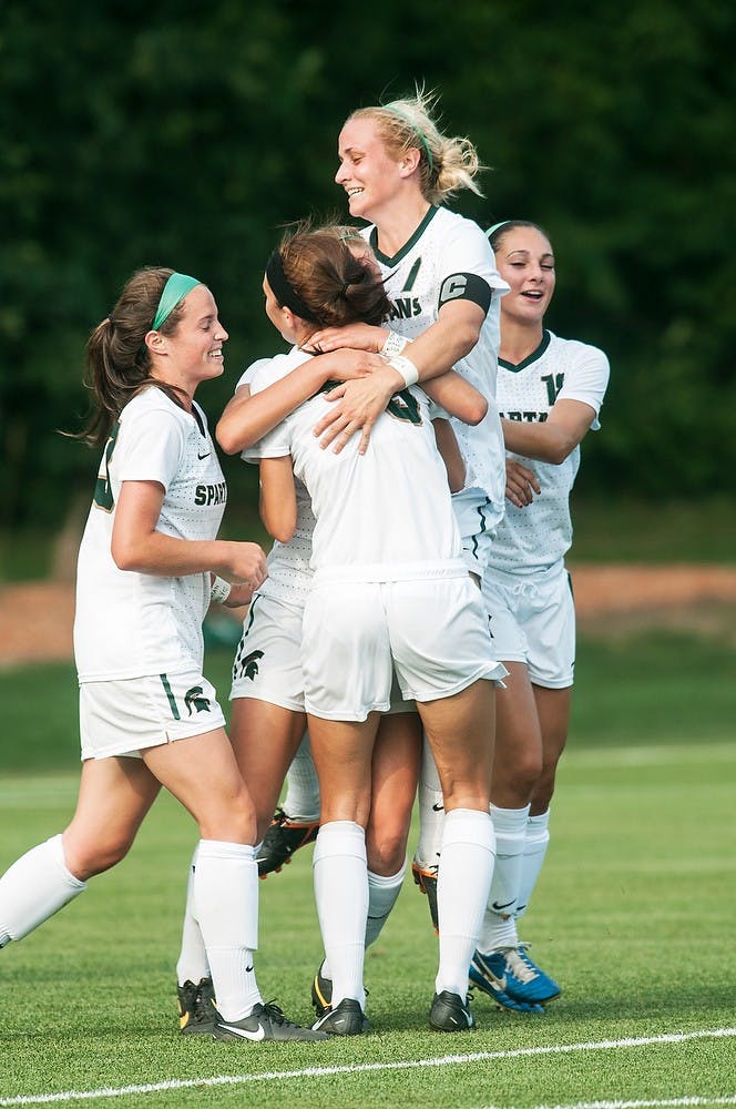 	<p>Sophomore defender Mary Kathryn Fiebernitz celebrates with teammates after a goal during their game against San Diego State, Aug. 30, 2013, at DeMartin Soccer Stadium. The Spartans tied with the No. 21 ranked San Diego State Aztecs, 1-1. Danyelle Morrow/The State News</p>