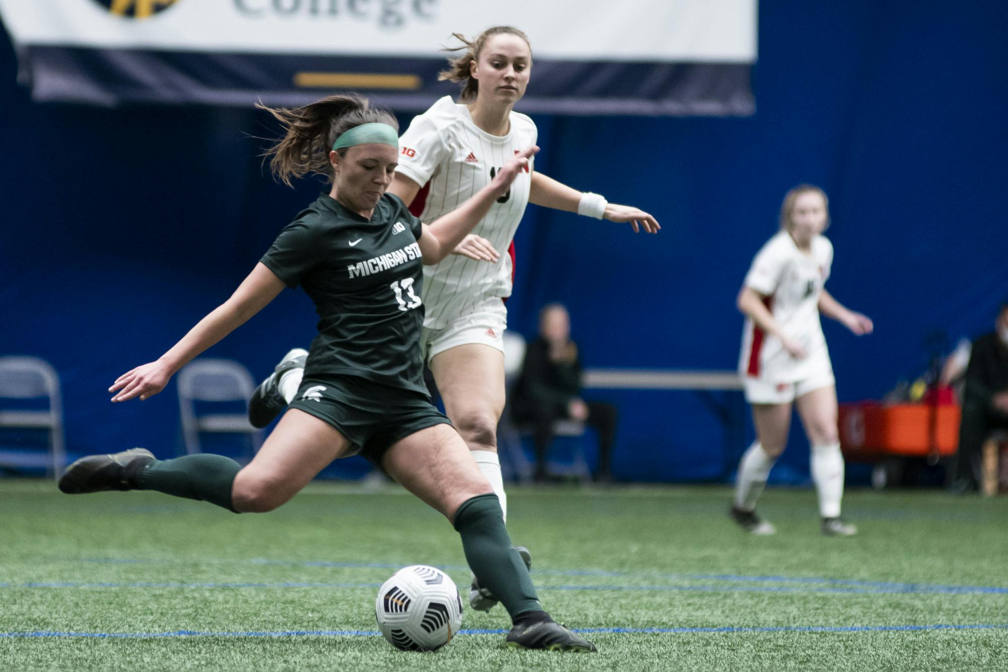 Senior defense Athena Biondi (13) kicks the ball during the game against Nebraska on February 25, 2021, at The St. Joe's Sports Dome. The Spartans defeated the Cornhuskers 2-0.