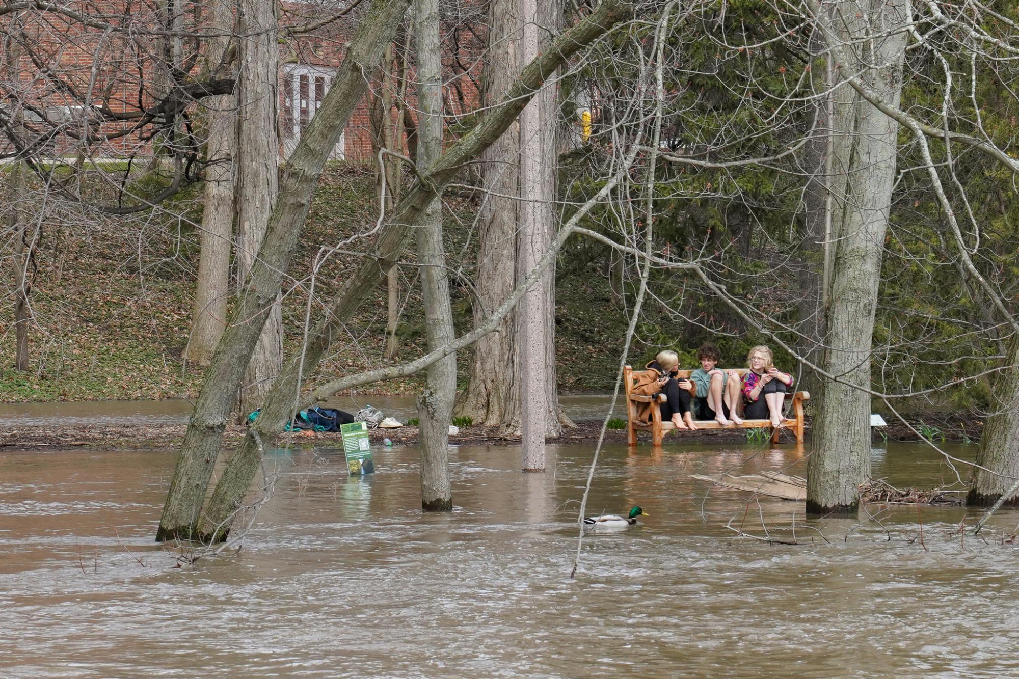 Students enjoy the warm storm weather after a heavy rainfall on campus on April 5, 2023. 