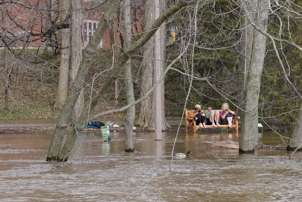 Students enjoy the warm storm weather after a heavy rainfall on campus on April 5, 2023. 
