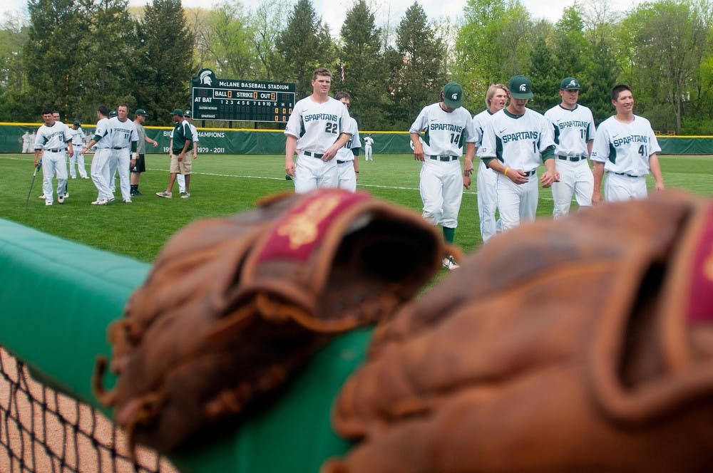 	<p>Spartan players walk off the field after warming up before the game on May 8, 2013, at McLane Baseball Stadium at Old College Field. The Spartans beat Eastern Michigan 6-3. Danyelle Morrow/The State News</p>