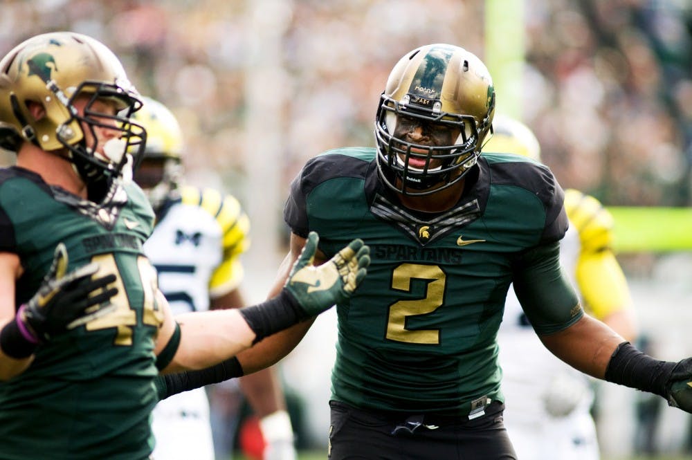 Sophomore defensive end William Gholston, right, and red-shirt freshman defensive end Marcus Rush throw their hands up to the referee after a roughing the passer call was made on Rush during Saturday's game against Michigan at Spartan Stadium. Lauren Wood/The State News