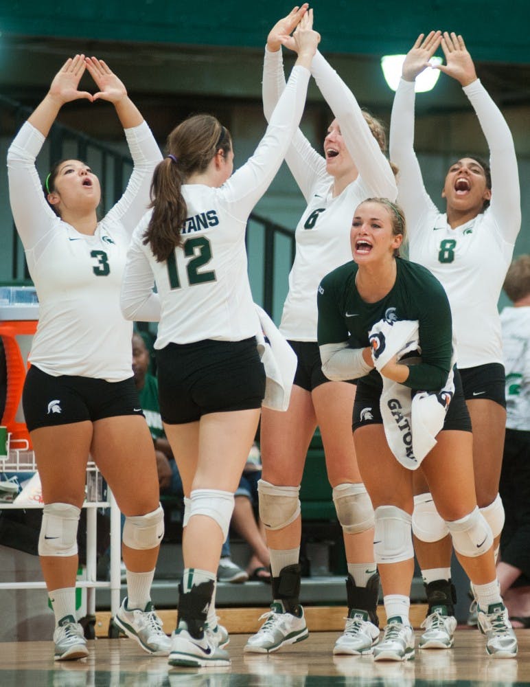 Sophomore libero Kori Moste, center, cheers with other teammates on Friday, Sept. 7, 2012 at Jenison Field House as the Spartans secure a point in late set five. MSU defeated IPFW, 3-2. Justin Wan/The State News