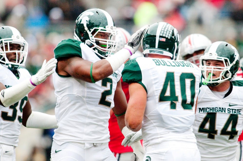 Sophomore linebacker William Gholston taps sophomore linebacker Max Bullough on the helmet after he sacked Ohio State quarterback Braxton Miller. The Spartans defeated Ohio State, 10-7, for the first time since 1999 on Saturday afternoon at Ohio Stadium in Columbus, Ohio. Josh Radtke/The State News