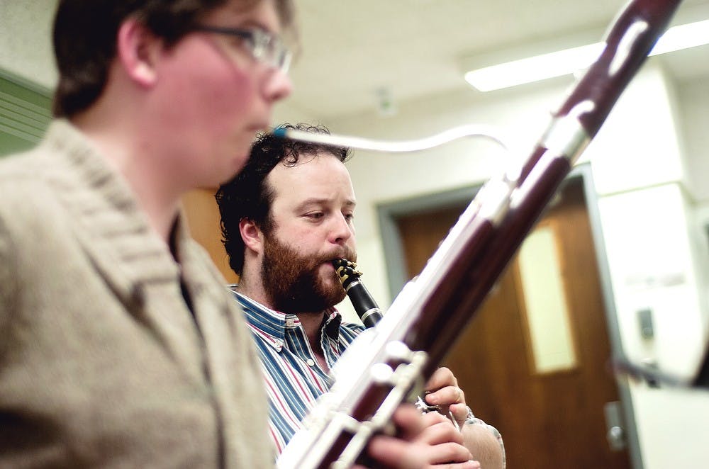 <p>Doctoral student Sam Davies, right, and bassoon performance and music performance senior John Kriewall, left, practice Wind Quintet One by Endre Szervanszky, March 27, 2014, in the Music Practice Building. The piece is for music education junior Megan Fritz's concert on April 5. Emily Jenks/The State News</p>