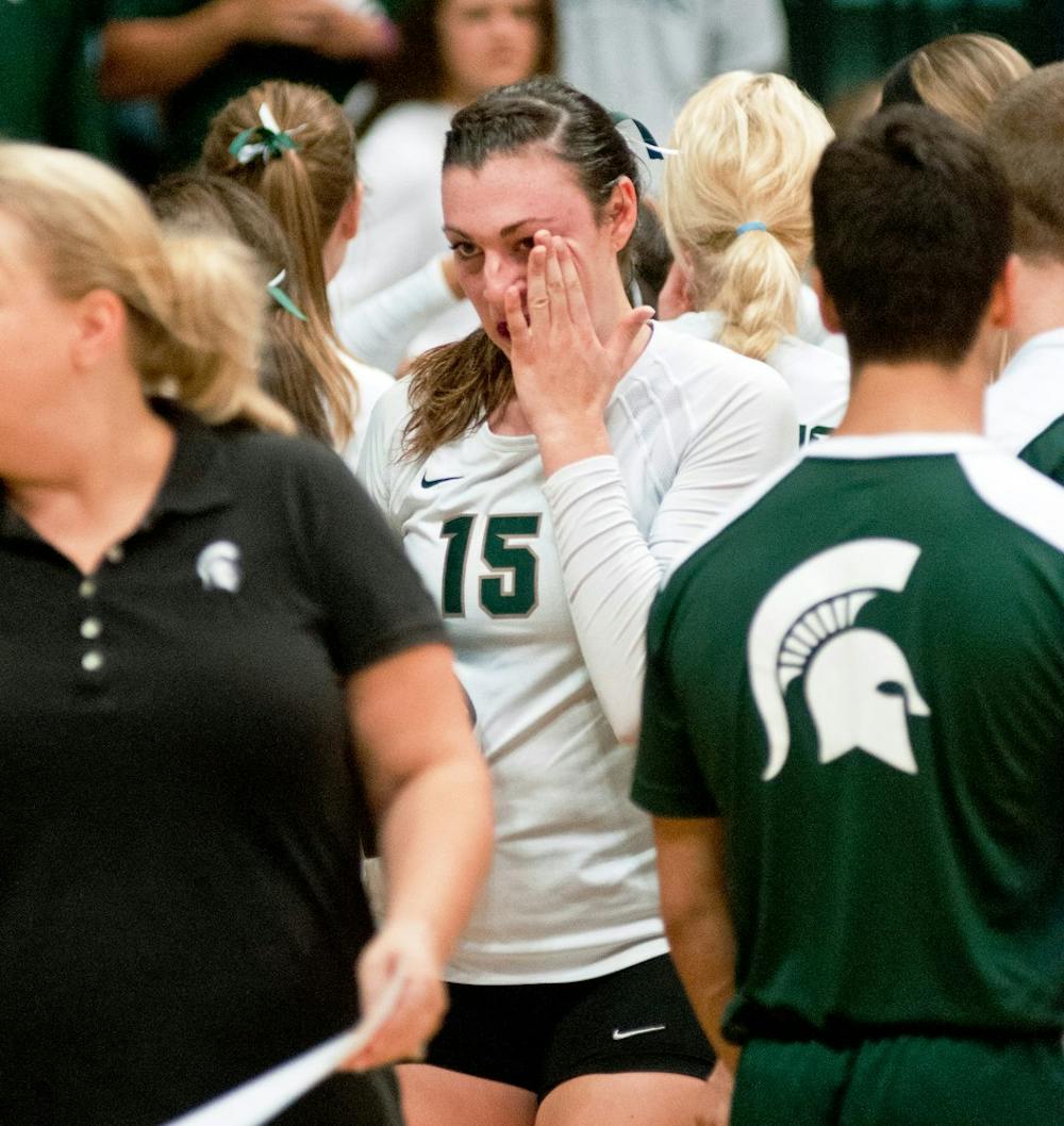 	<p>Senior outside hitter Lauren Wicinski gets emotional after celebrating with the student section Sept. 20, 2013 at Jenison Field House. Wicinski ended the night having made over two thousand kills in her career. Khoa Nguyen/ The State News</p>