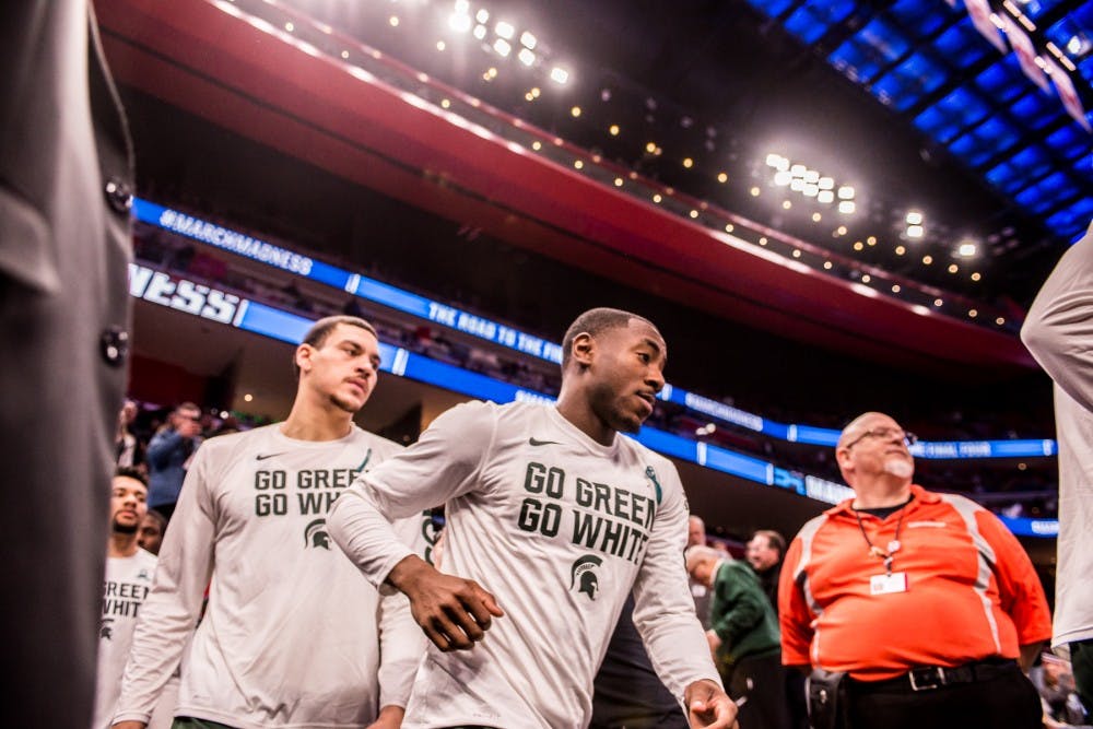 <p>Spartans enter the court for the first round of the NCAA tournament against Bucknell on March 16, 2018 at Little Caesars Arena in Detroit.&nbsp;</p>