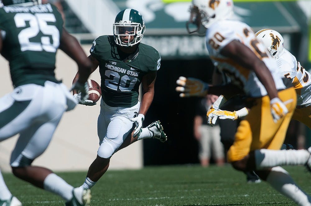 <p>Senior running back Nick Hill makes his way down the field during the game against Wyoming on Sept. 27, 2014, at Spartan Stadium. The Spartans defeated the Cowboys, 56-14. Julia Nagy/The State News</p>