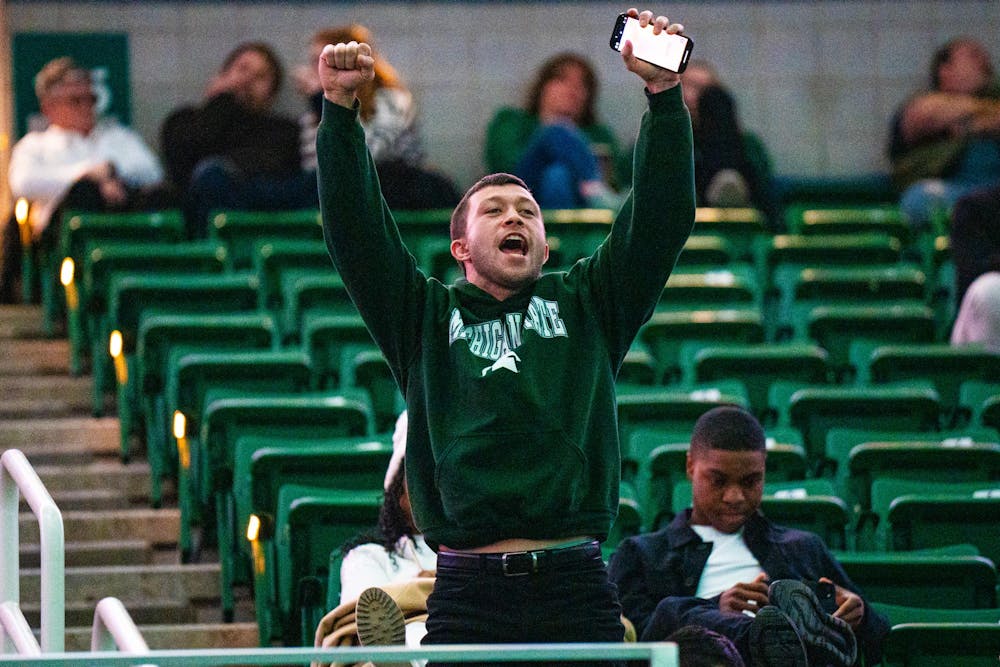 An attendee cheers on an MSU alumnus during the fall 2024 commencement ceremony at the Breslin Center on Dec. 14, 2024.