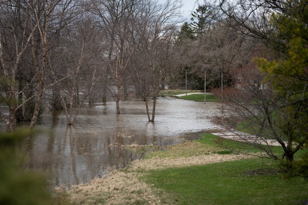The Red Cedar River overflows and floods the sidewalks after heavy rainfall on campus on April 5, 2023. 