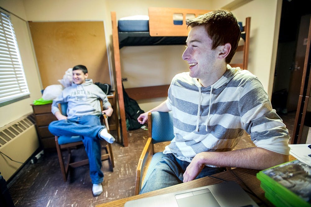 	<p>Marketing freshman Danny Savard, right, who transferred to <span class="caps">MSU</span> this semester from Schoolcraft College after one semester, watches a football game with his childhood friend, accounting freshman Chris Shim in McDonel Hall on Jan. 6, 2013. Savard said he always wanted to be a Spartan but wasn&#8217;t able to get a room on campus last semester.</p>
