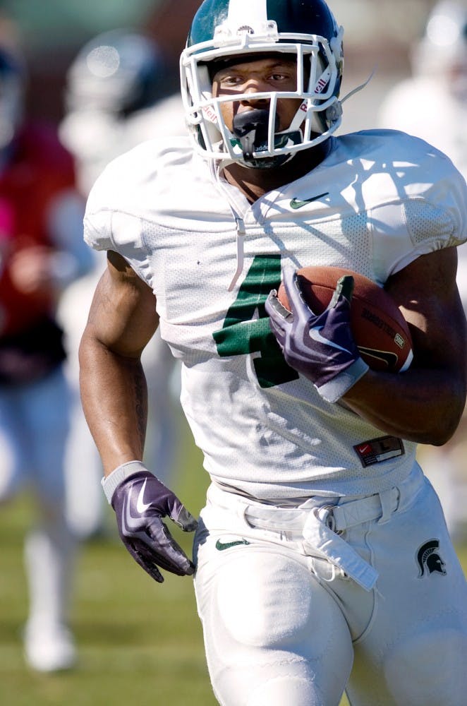 Junior running back Edwin Baker runs towards the endzone during a drill Tuesday outside the Duffy Daugherty Football Building. The Spartans held practice Tuesday in preparation for the 2011 season. Matt Radick/The State News