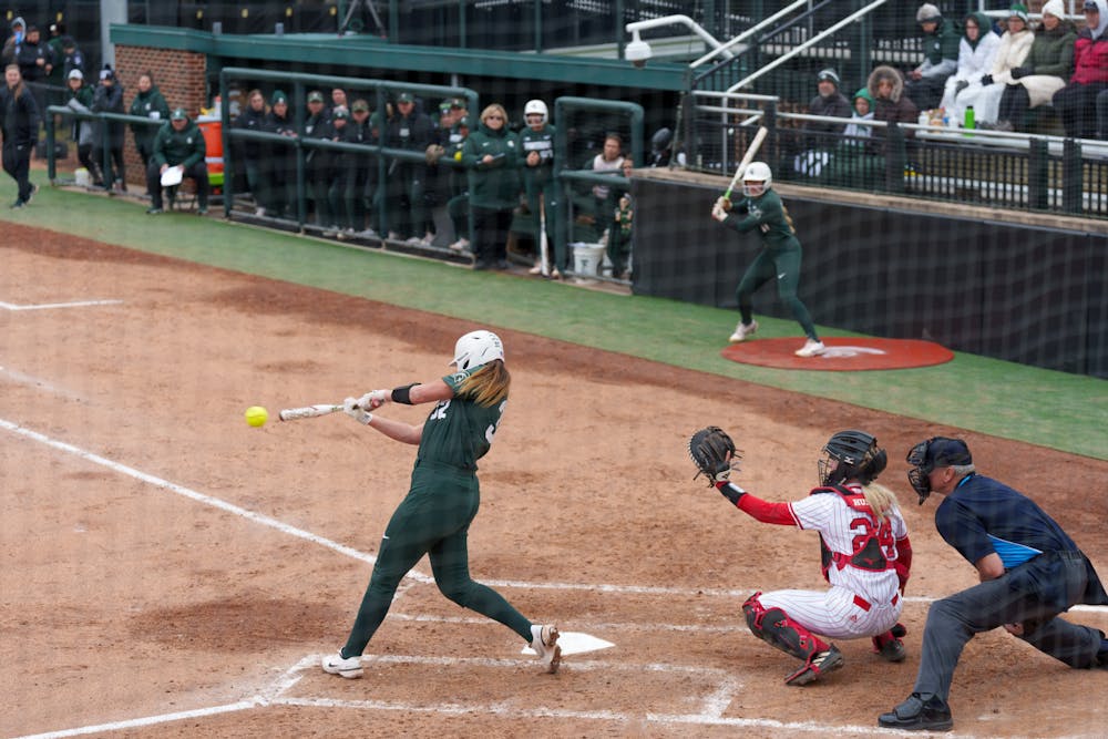<p>Michigan State sophomore Alexis Barroso hits a foul ball into the air in the second inning. Spartans lost 6-0 against Nebraska, on April 9, 2022.</p>