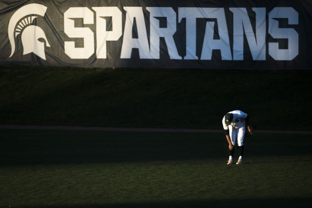Freshman outfielder Casey Mayes (33) stretches during the baseball game against Oakland University at McLane Baseball Stadium on April 23, 2019. (Nic Antaya/The State News)