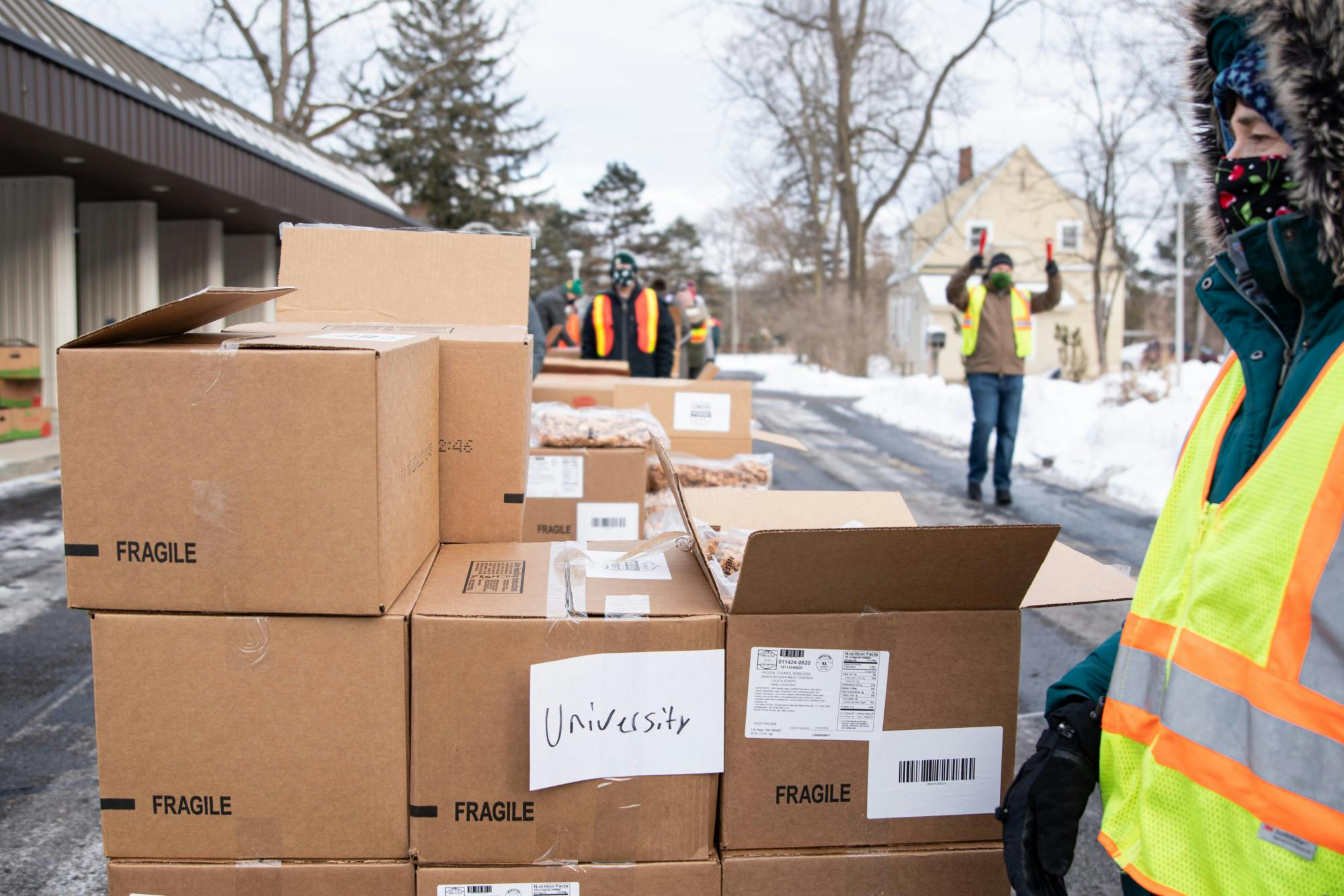 Katie Hanson, a member of the United Methodist Church-University,  volunteers at a Greater Lansing Food Bank distribution at the University Lutheran Church on Jan. 28, 2021. "It's a way we can contribute and do so safely."