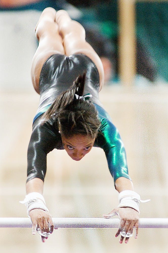 	<p>During her third year with the team, Taira Neal competes on the uneven parallel bars at the gymnastics meet against Pittsburgh on Feb. 12, 2012, at Jenison Field House.</p>
