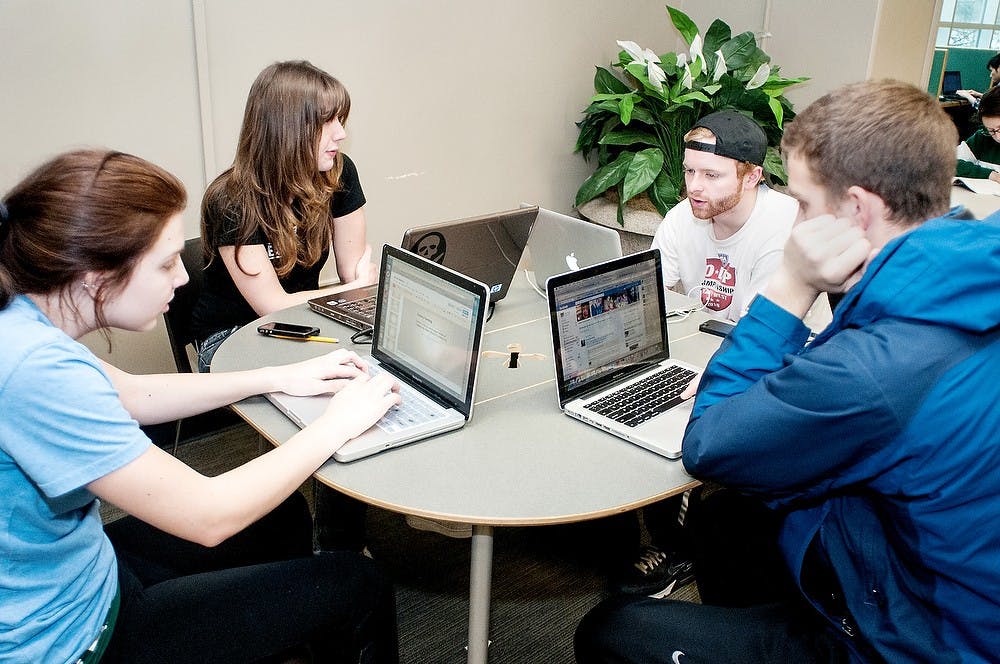 	<p>From left, business junior Erica Sherwood, marketing senior Kaitlin Flannery, hospitality business freshman Eddie Wicks and hospitality business sophomore Evan Smith talk about their group project on Sunday, Feb. 10, 2013 at the Main Library.  Their project was for their HB 265 class.</p>