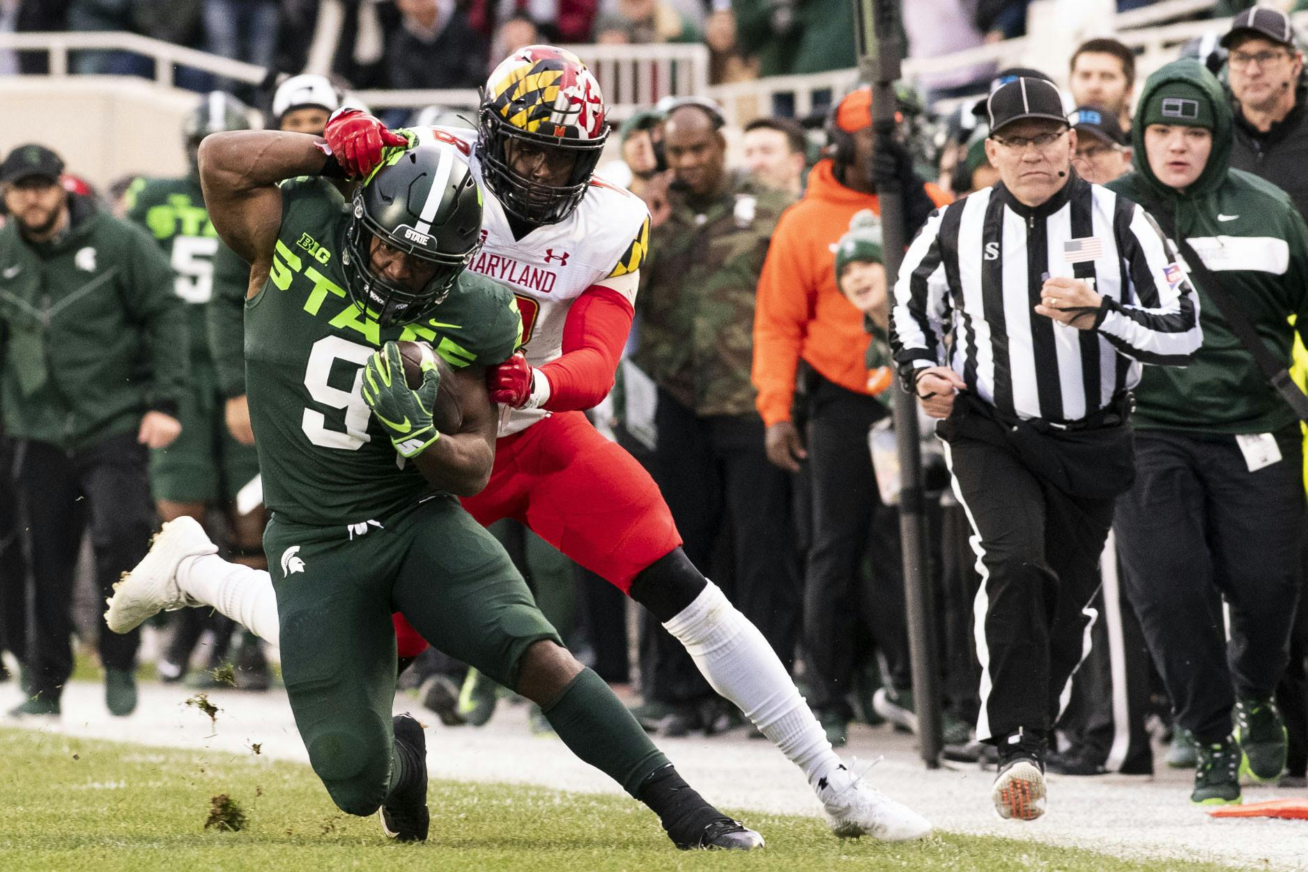 <p>Junior running back Kenneth Walker III (9) gets grabbed while running the ball during the game against Maryland on Nov. 13, 2021, at the Spartan Stadium.</p>