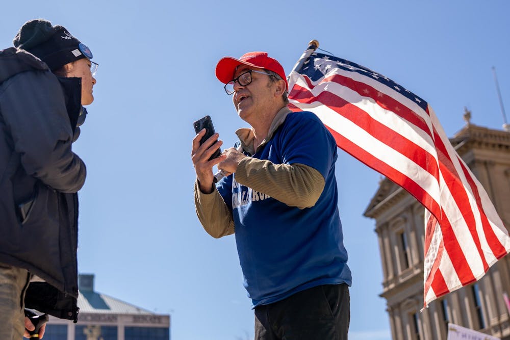 <p>Two protestors from opposing sides engage in a debate during the No Kings Protest at the Michigan State Capitol in Lansing, MI on March 28, 2026.</p>