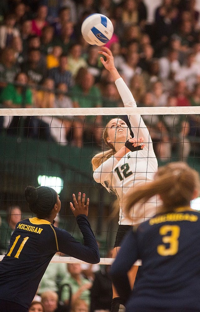 <p>Freshman setter Rachel Minarick spikes the ball Oct. 3, 2014, during a game against the University of Michigan at Jenison Fieldhouse. The Spartans defeated the Wolverines, 3-1. Erin Hampton/The State News</p>