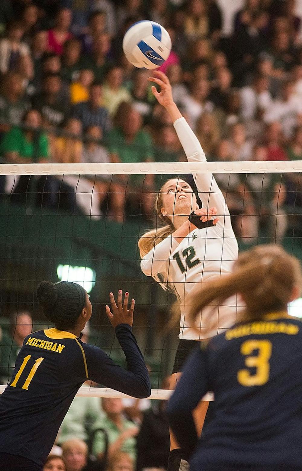 <p>Freshman setter Rachel Minarick spikes the ball Oct. 3, 2014, during a game against the University of Michigan at Jenison Fieldhouse. The Spartans defeated the Wolverines, 3-1. Erin Hampton/The State News</p>