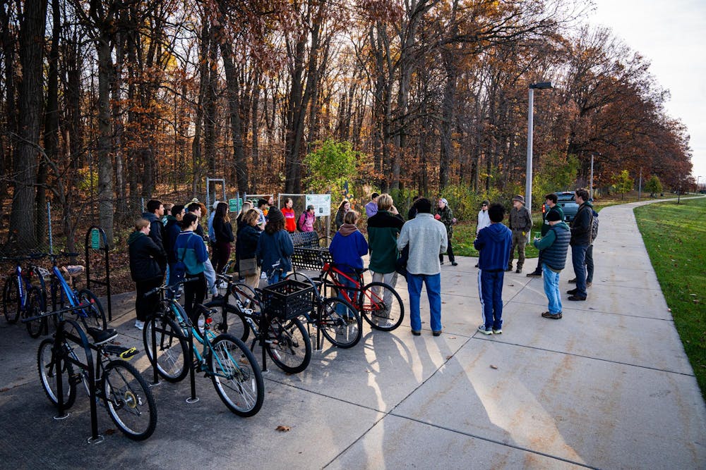 Students and community members gather moments before an invasive species removal effort begins at the Baker Woodlot on Nov. 9, 2024.