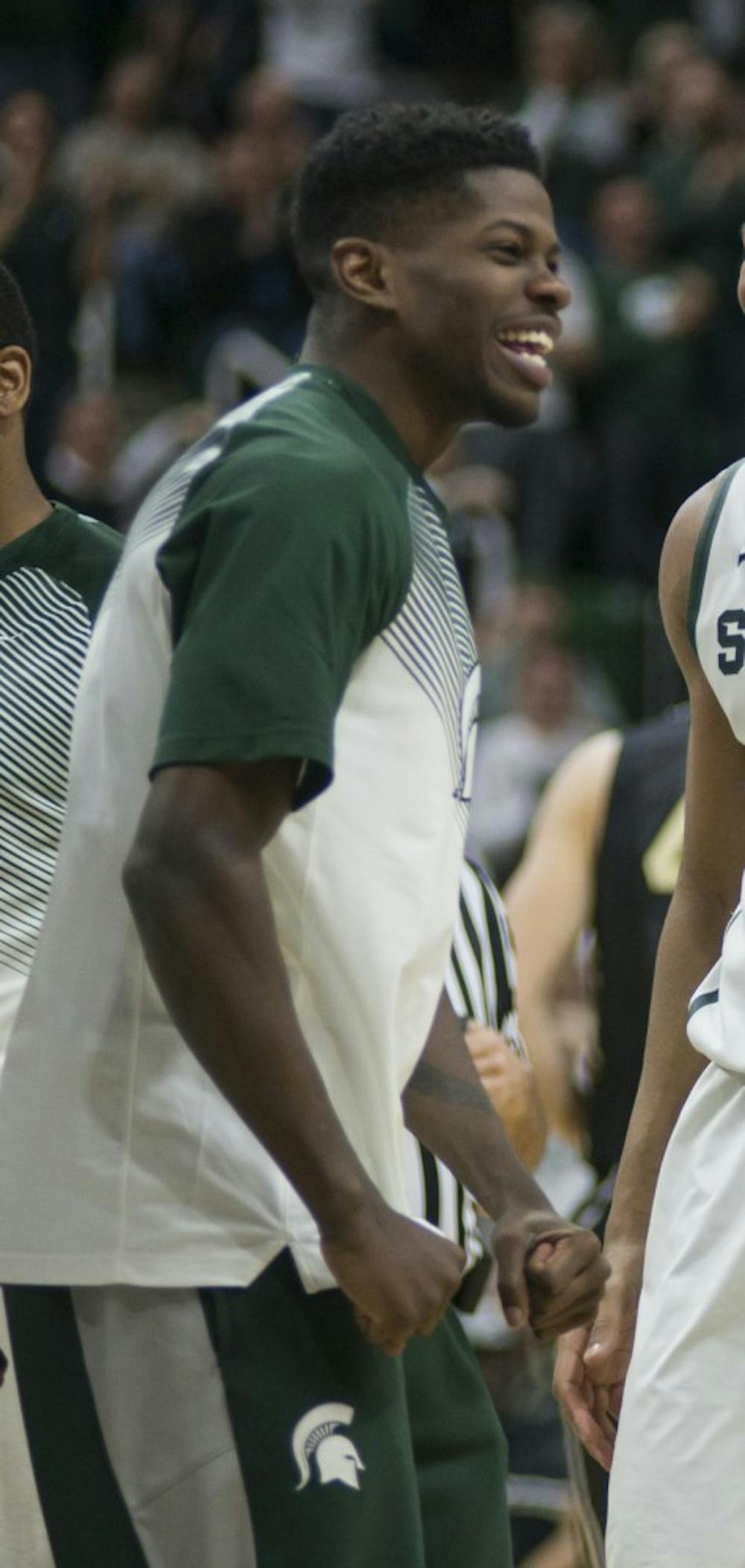 Michigan State Spartans guard Denzel Valentine (45), guard Eron Harris (14),  forward Marvin Clark Jr. (0) and forward Matt Costello (10) celebrate Costello's basket on Mar. 4, 2015, during the Michigan State basketball game against Purdue at Breslin Center, 534 Birch Rd. The Spartans defeated the Boilermakers, 72-66. Emily Nagle/The State News.