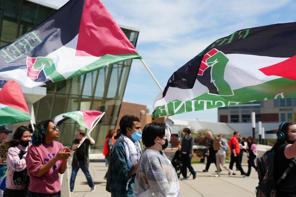 Protestors hold the Palestinian flag during a protest outside of the Breslin Center on April 26, 2024. Protestors demanded that the university divest from Israel. 