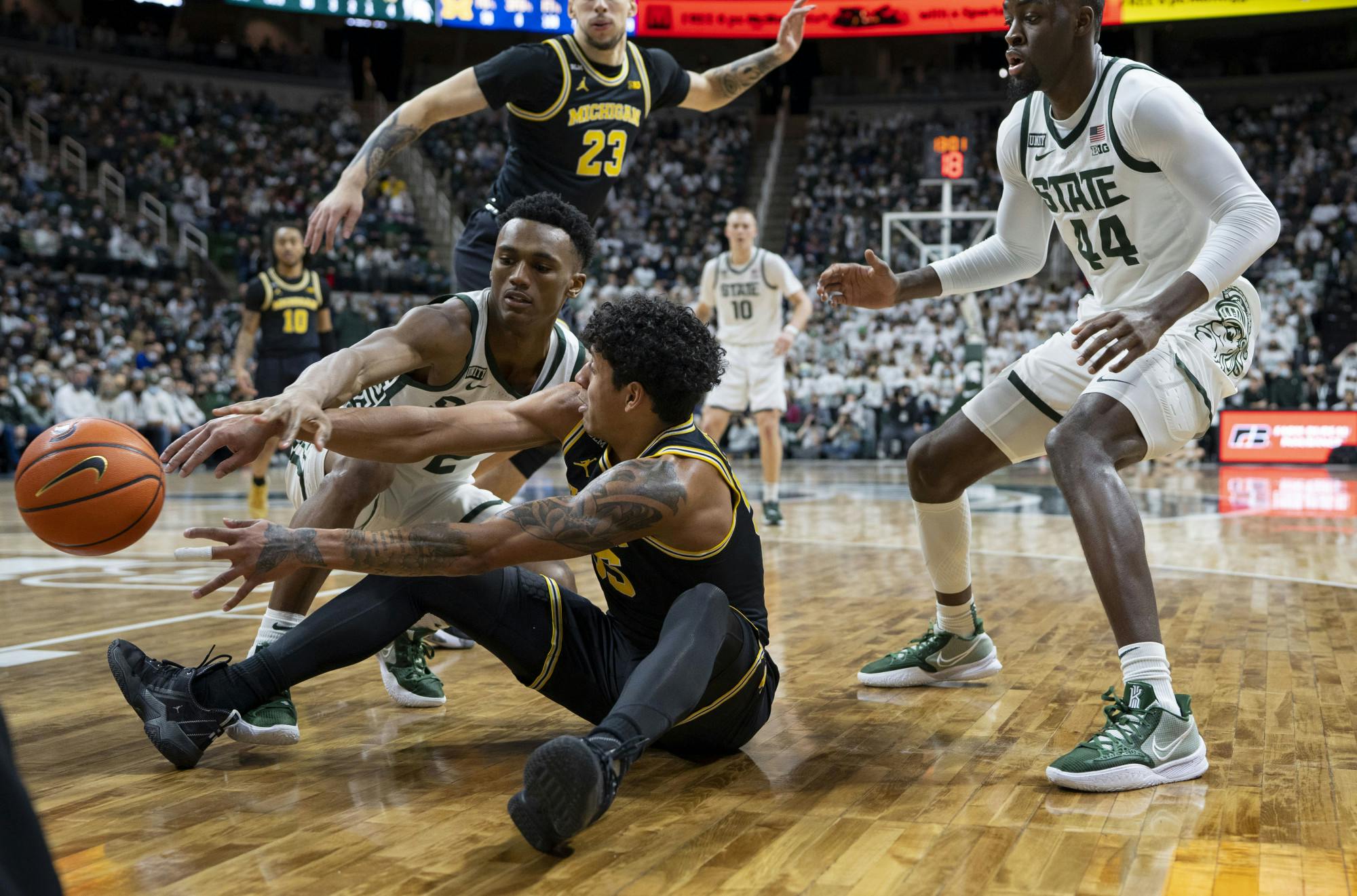 <p>MSU’s junior guard Tyson Walker (2) and Michigan’s graduate student guard Eli Brooks (55) grapple for possession during MSU’s game against the University of Michigan on Saturday, Jan. 29, 2022. The Spartans ultimately beat the Wolverines 83-67.</p>