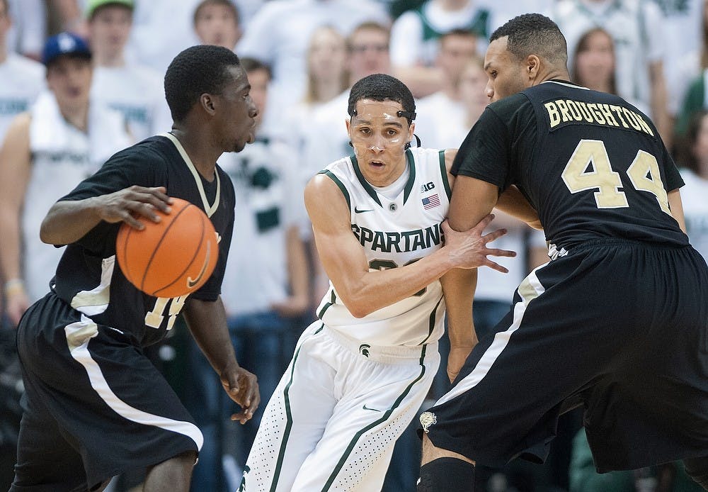 	<p>Golden Lion guard Tevin Hammond looks for a gap to move the ball closer to the baseline with sophomore guard Travis Trice trying to bypass Golden Lion guard Daniel Broughton. The Spartans defeated Arkansas-Pine Bluff 76-44 Wednesday, Dec. 5, 2012, at Breslin Center. Justin Wan/The State News</p>