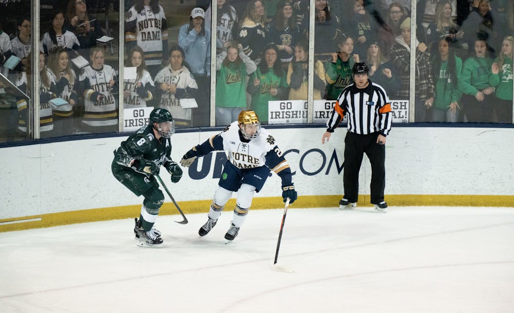 <p>MSU defenseman Cole Krygier and Notre Dame winger Jack Adams move to catch up with the play after a collision knocked the two to the ice at Compton Family Ice Arena in Notre Dame, IN on Friday, March 4, 2023. The Spartans and the Fighting Irish will battle it out one more time on Sunday, March 5, 2023.</p>