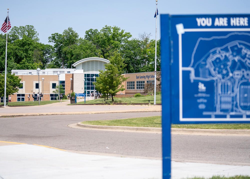 Students and faculty walk into the front doors of East Lansing High School on May 24, 2024.