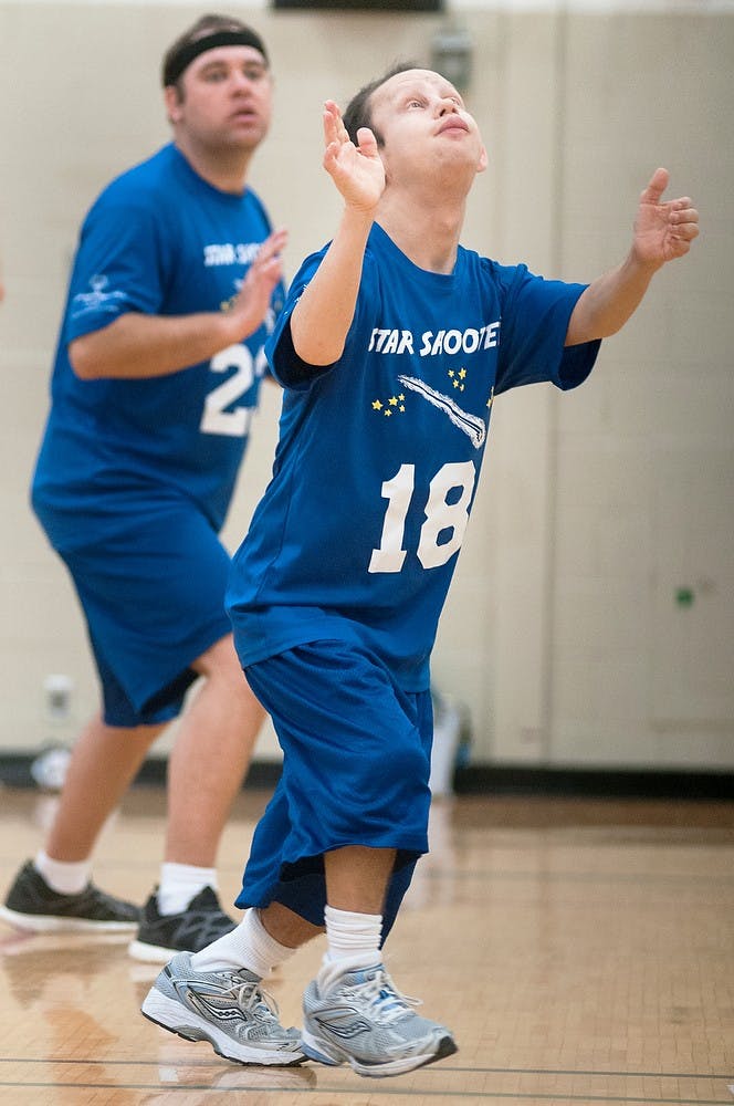 	<p>Donny Vanderwal of the Special Olympics Michigan Area 8 &#8220;Star Shooters&#8221; volleyball team prepares to set the ball during a fundraiser hosted by the Council of Graduate Students (<span class="caps">COGS</span>), Greek Life, and Graduate Wellness on Saturday, March 30, 2013, in the gym of IM Sports-West. The proceeds of the event were donated in full to the Special Olympics Michigan during the first-annual fundraiser. Danyelle Morrow/The State News</p>