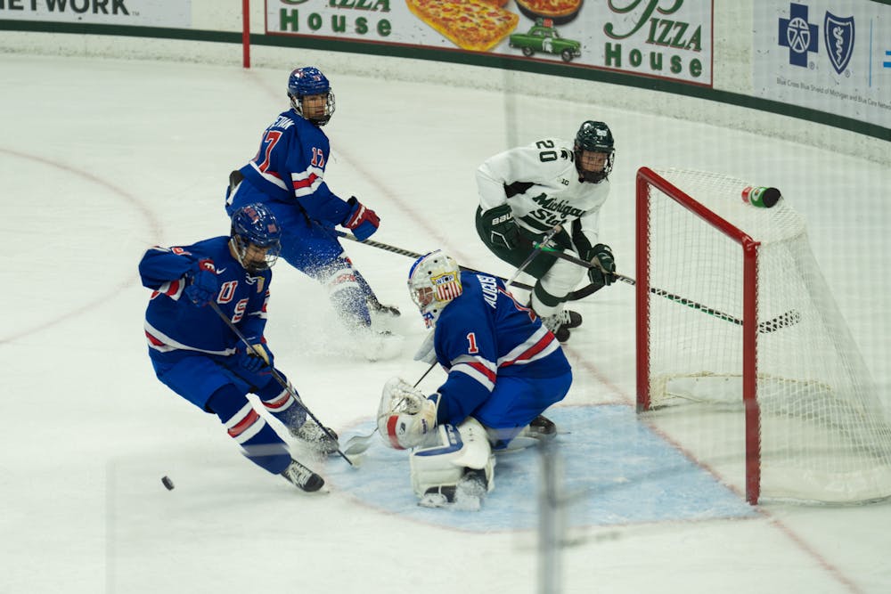 <p>Junior right wing Daniel Russell (20) attempts to score at Munn Ice Arena on Oct. 1, 2022. The Spartans lost to the USNTDP 4-3.</p>