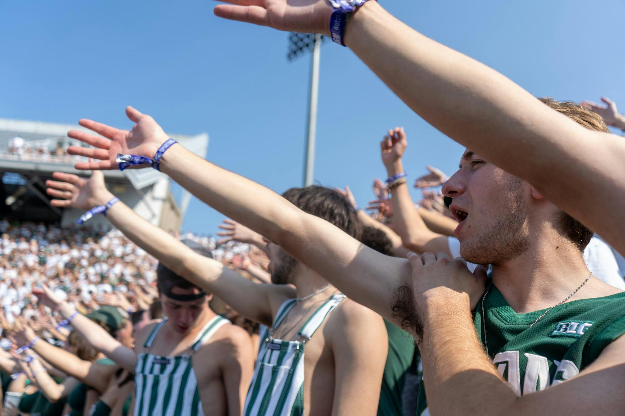 <p>MSU students yell ‘Go green’ to the opposite side of the student section in Spartan Stadium on Sept. 14, 2024. The Spartans defeated the Prairie View A&amp;M Panthers, 40-0.</p>