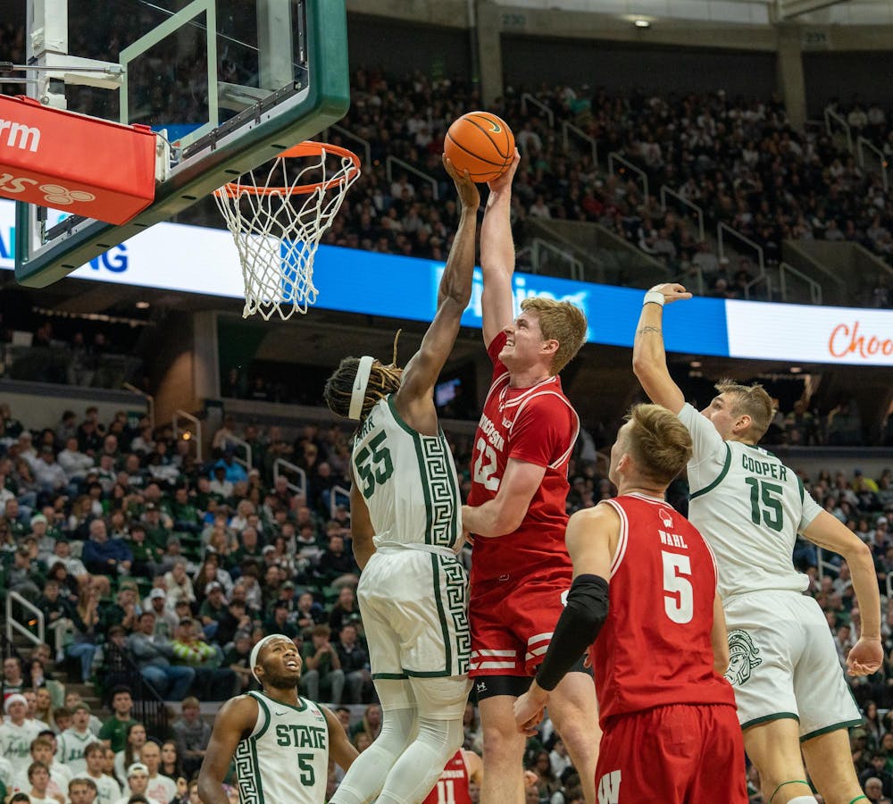<p>MSU Freshman Forward Coen Carr (55) blocks a shot during a play against Wisconsin at the Breslin Center on Dec. 5, 2023. MSU would go on to lose 57-70 against 23 Wisconsin.</p>