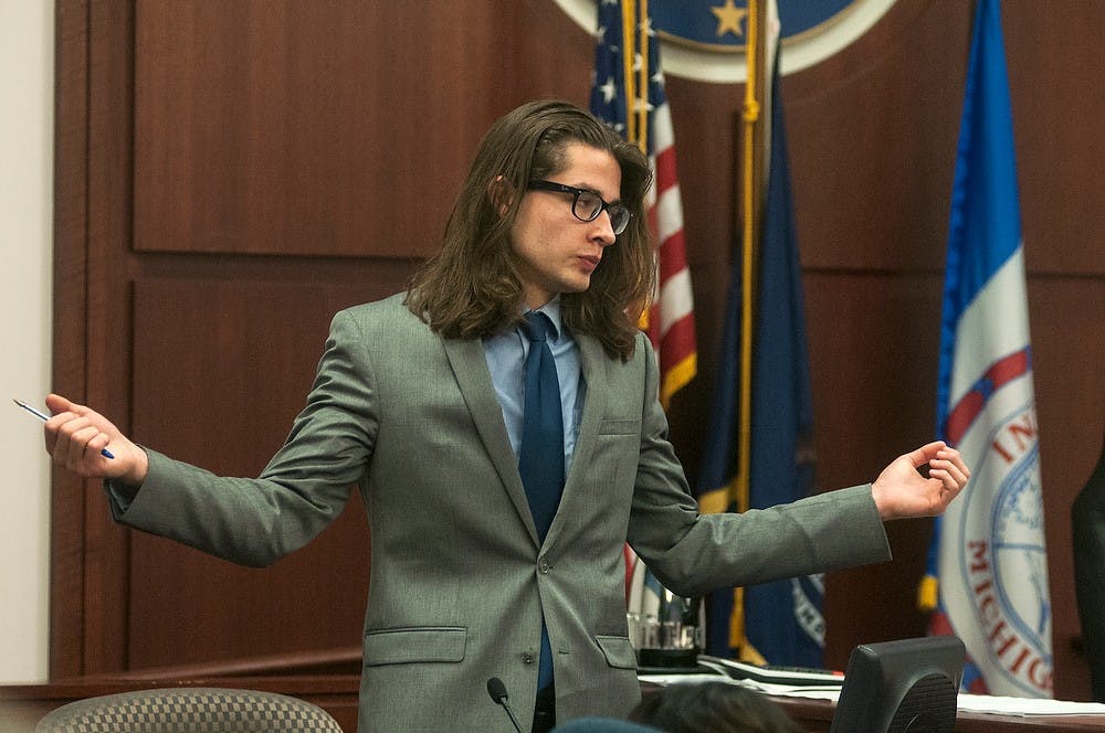 	<p>Tyler Aho, former roommate of slain <span class="caps">MSU</span> student Andrew Singler, demonstrates to the jury how alleged murderer Connor McCowan approached the door on the night Singler was killed last February. The trial began Tuesday, Oct. 1, 2013 with opening statements and witness testimony. Danyelle Morrow/The State News</p>