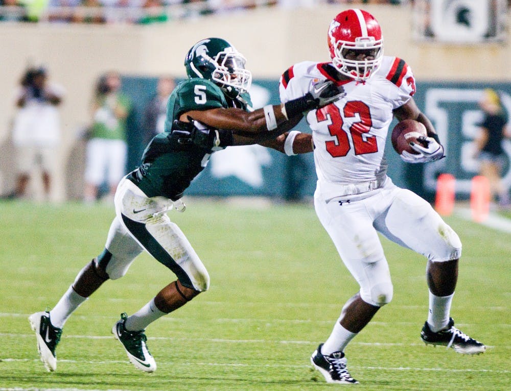 Junior cornerback Johnny Adams wraps up Youngstown State tailback Jordan Thompson Friday at Spartan Stadium. The Spartans defeated the Penguins, 28-6. Matt Radick/The State News