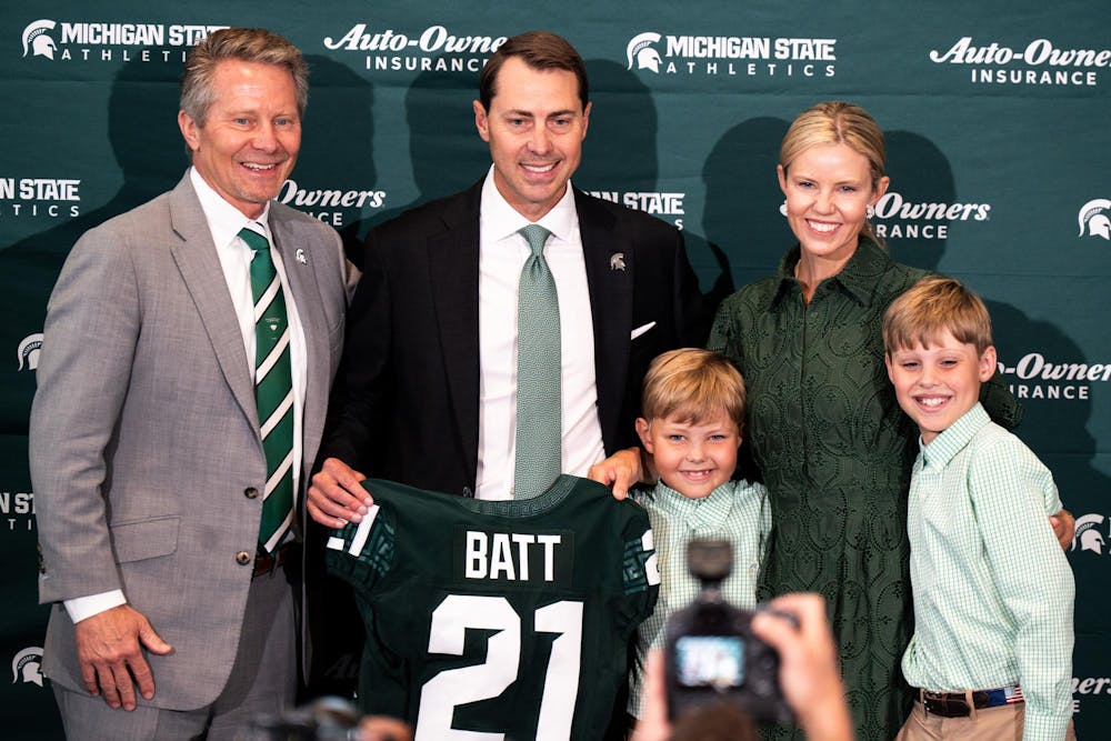 Michigan State University president Kevin Guskiewicz , new vice president and athletic director J. Batt and his family pose for a photo in East Lansing, Michigan on June 4, 2025.