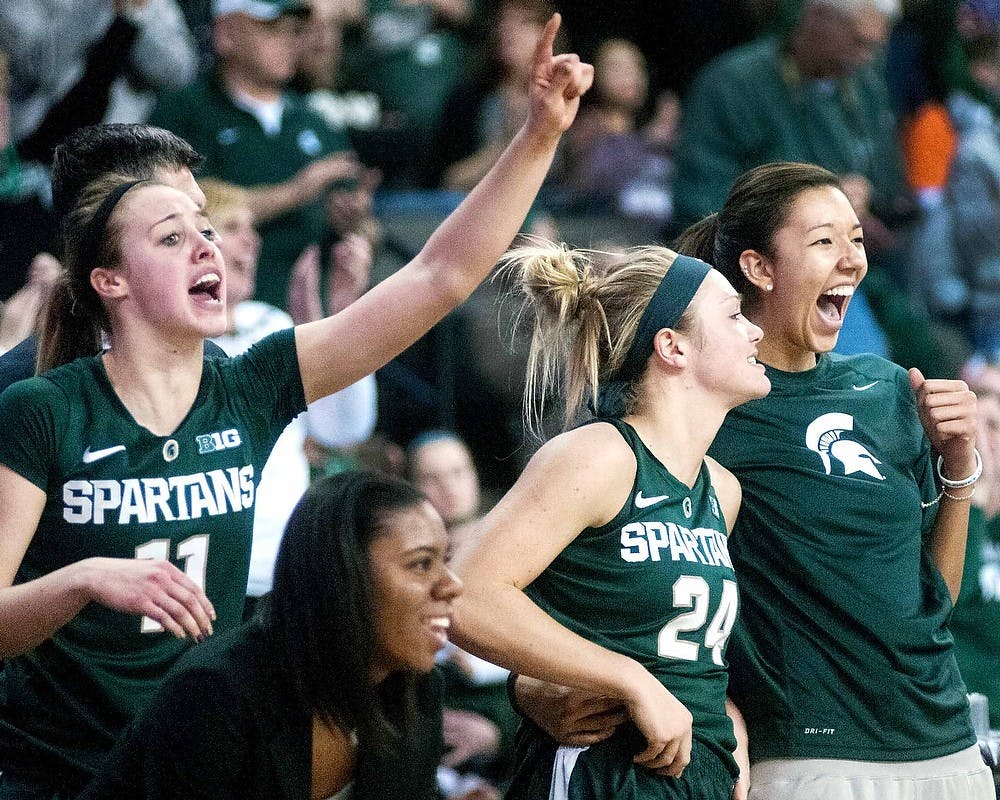 From left to right junior forward Annalise Pickrel, senior forward Courtney Schiffauer and sophomore center Madison Williams cheer near the end of the game against Penn State on March, 9, 2013, at Sears Centre in Hoffman Estates, Ill. during the Big Ten Tournament. The Spartans defeated the Nittany Lions 54-46. Julia Nagy/The State News  